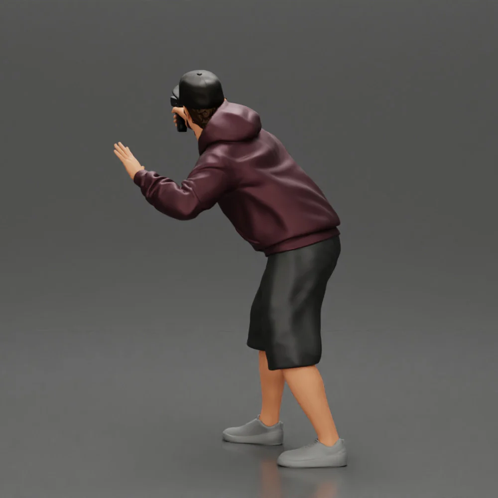 gangster man in a hoodie and cap shooting a gun behind the car - Image 7