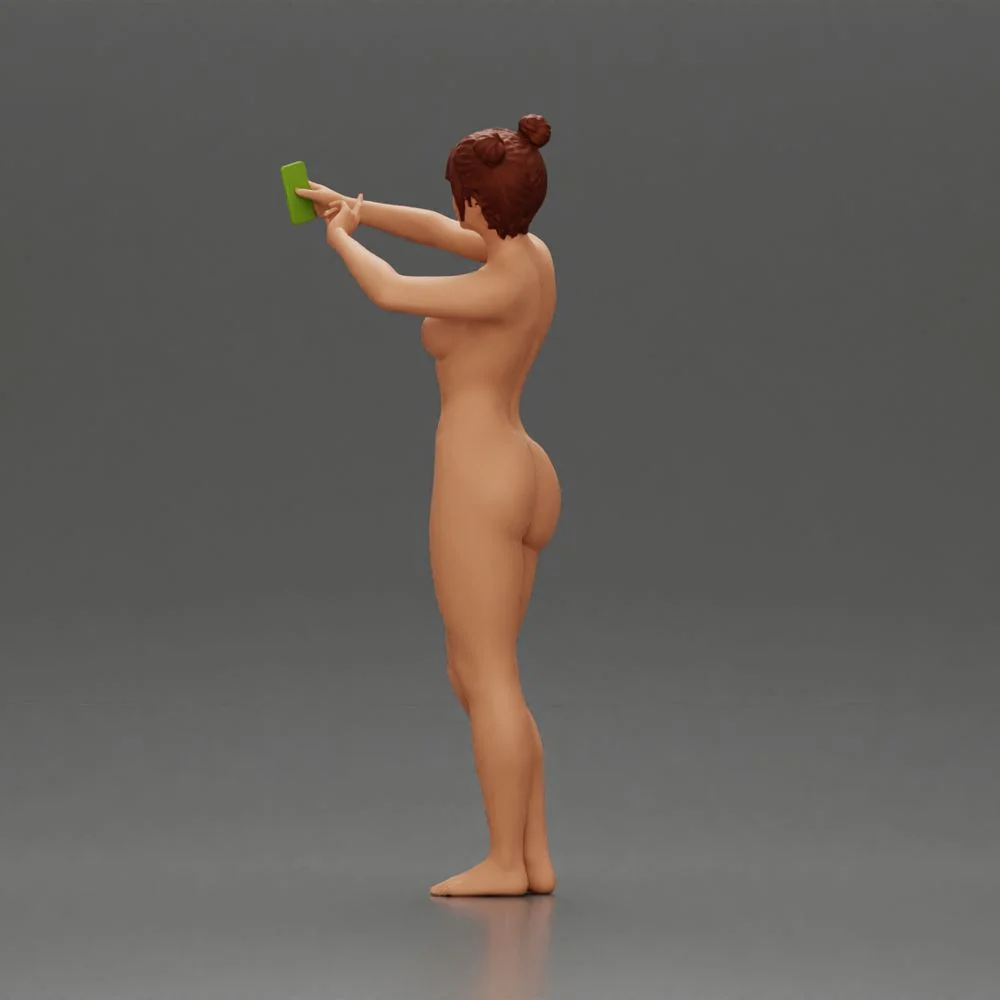 Naked woman taking a selfie with her phone on the beach - Image 6